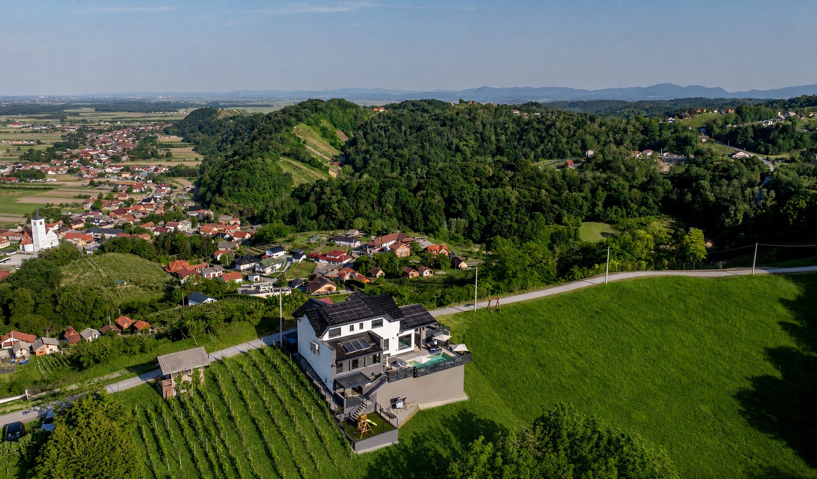 Villa Iva from the air — vineyards and valley near Cestica